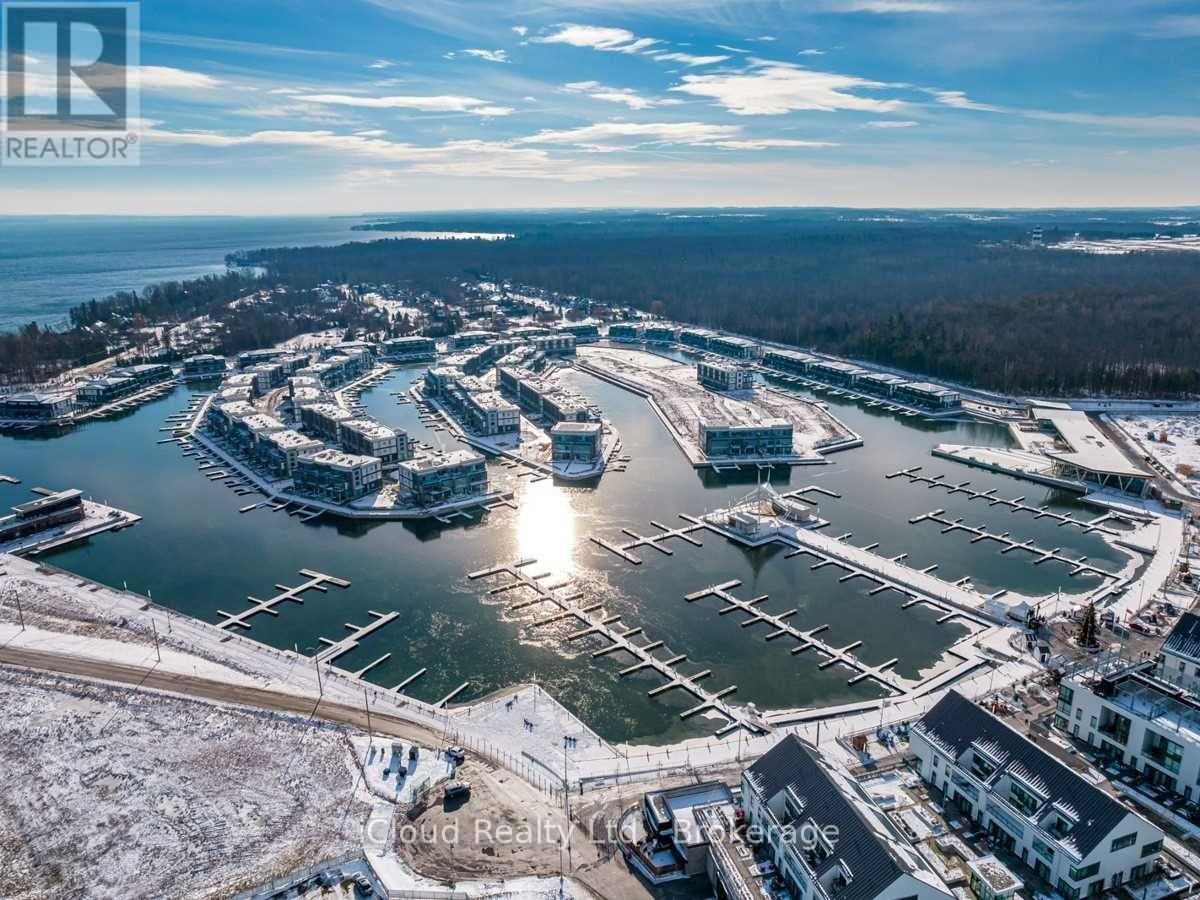 A marina with boats docked in the water and buildings surrounding it.