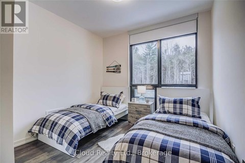 Two bedrooms with blue and white bedding in a real estate listing.