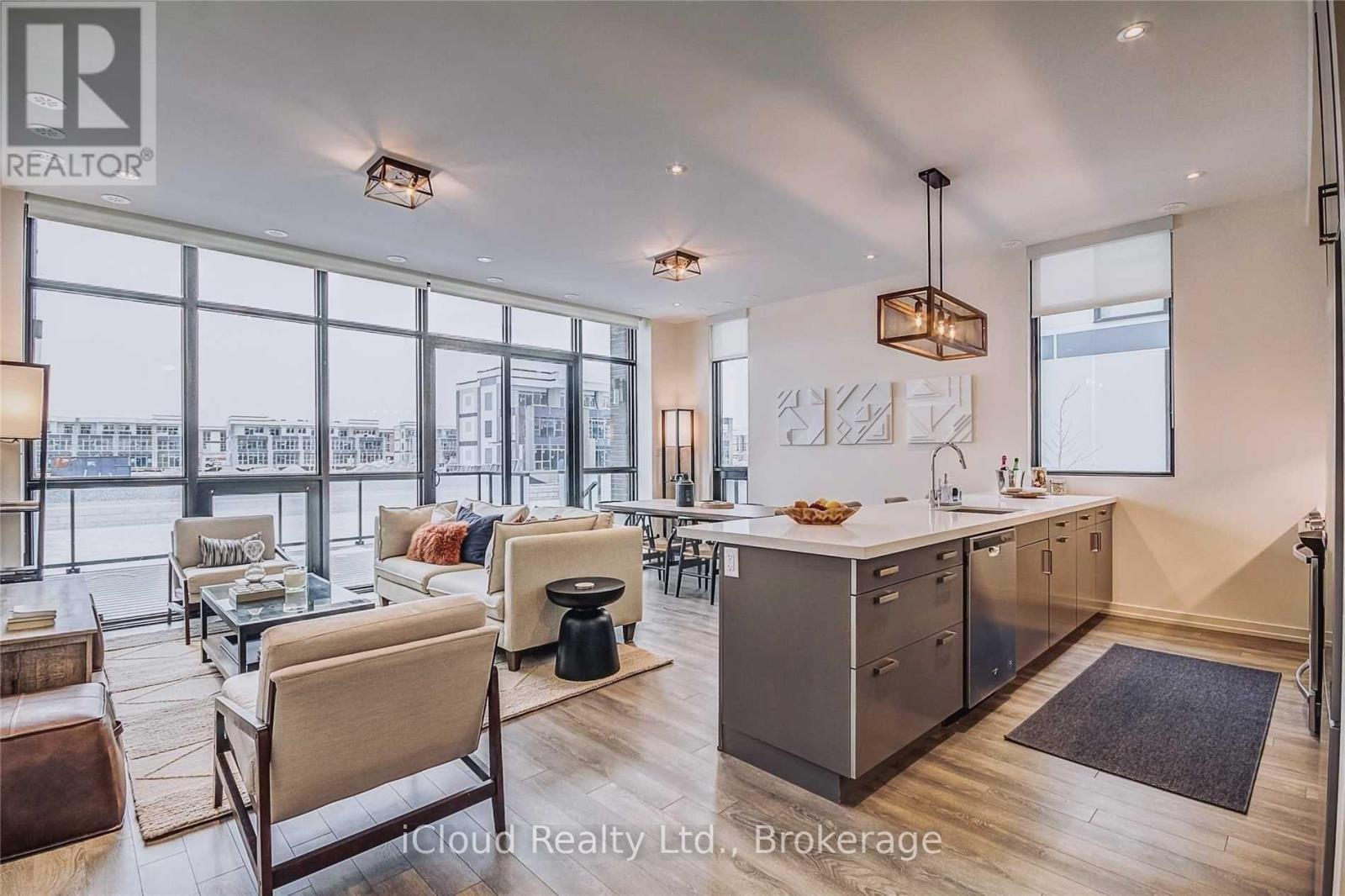 A modern kitchen and living room with a view of the city.