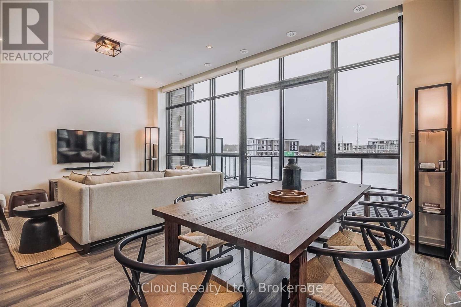 A modern dining room with a large table and chairs.