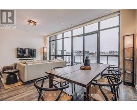 A modern dining room with a large table and chairs.