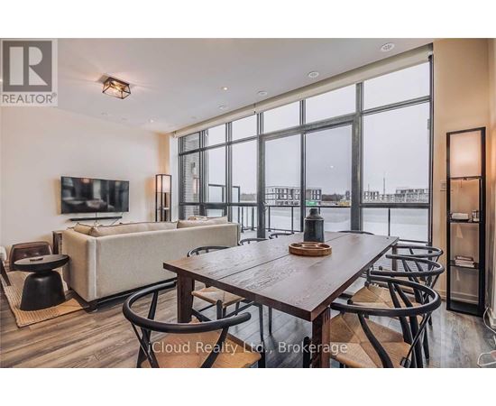 A modern dining room with a large table and chairs.