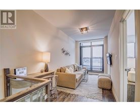 A living room with a glass table, a sofa, a chair, and a sign that says "Welcome Home".