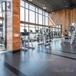 A gym with a variety of equipment and a large window.