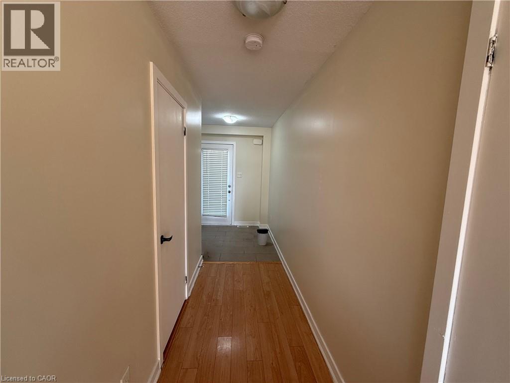 A hallway with a door on the left and another door on the right.