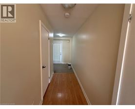 A hallway with a door on the left and another door on the right.