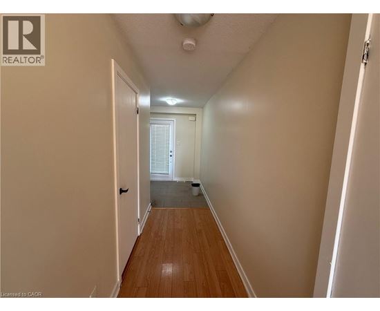 A hallway with a door on the left and another door on the right.