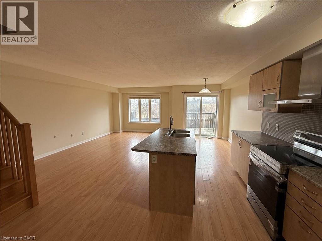 A kitchen with wooden floors and a large island in the middle.
