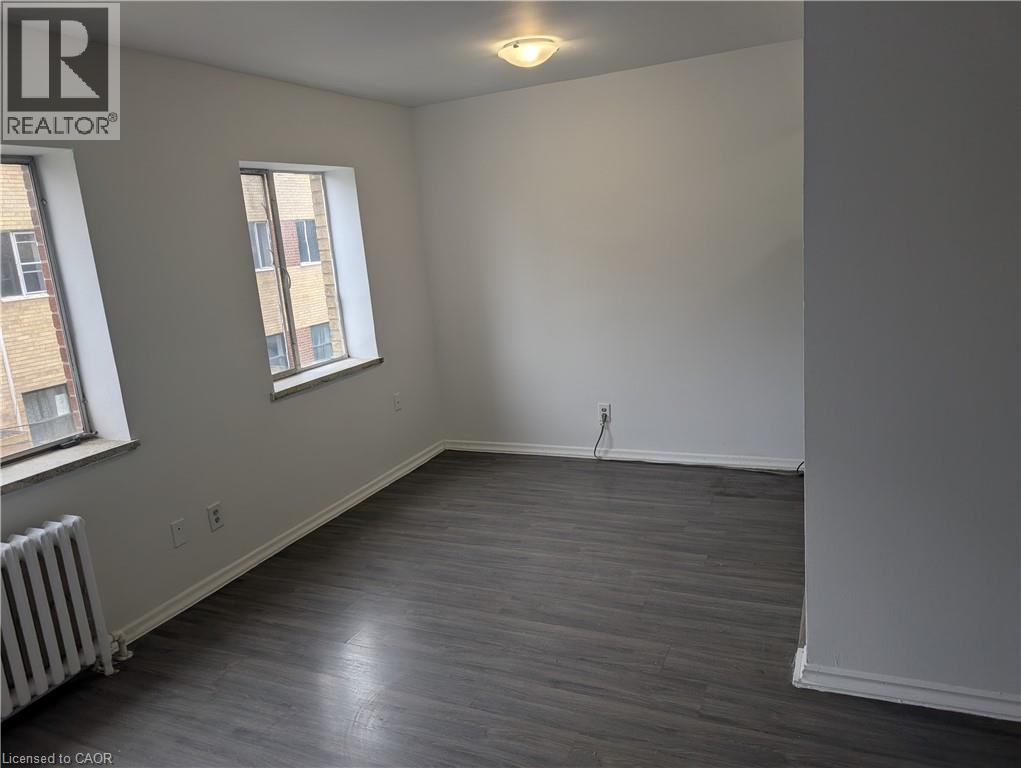 A room with a window and a radiator on the wall.