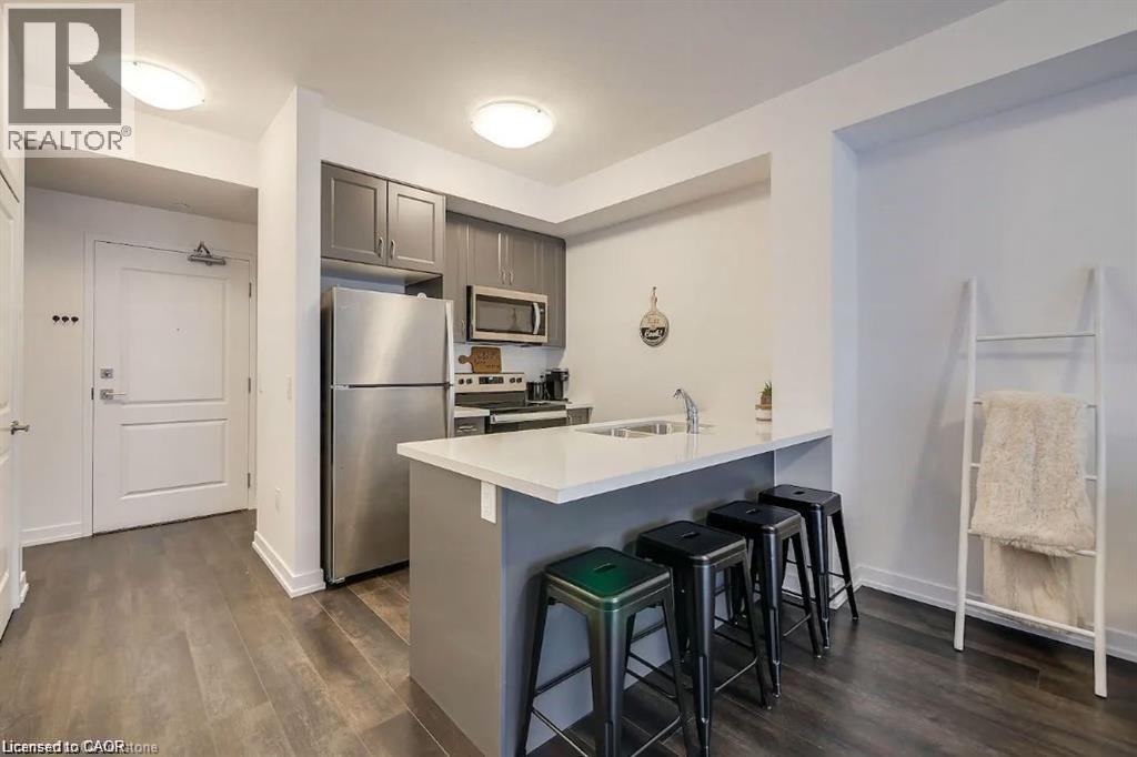 A kitchen with a white countertop and stainless steel appliances.