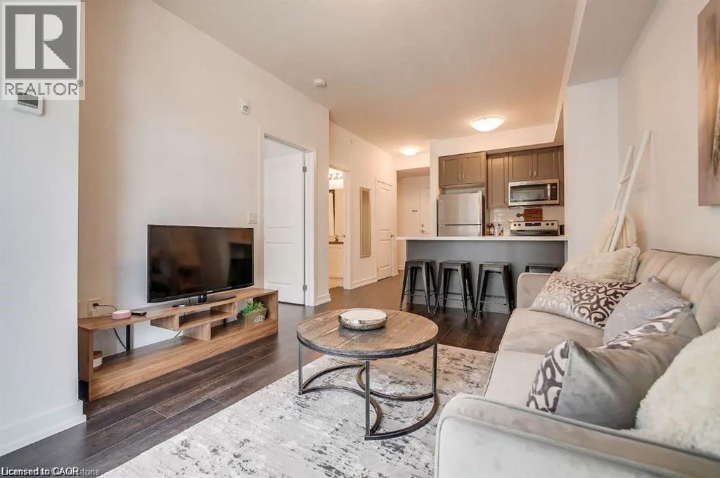 A living room with a white couch and a television.
