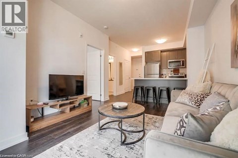 A living room with a white couch and a television.