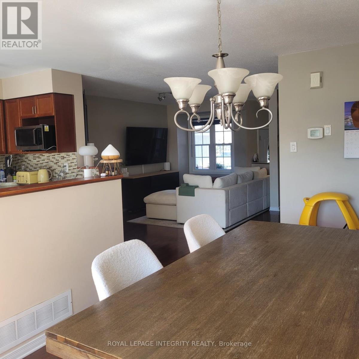 A dining room with a wooden table and chairs.