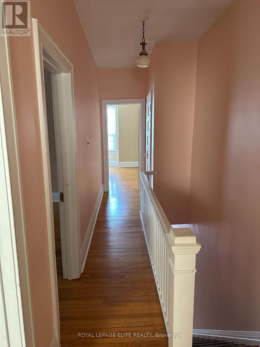 A long hallway with a light on the ceiling.