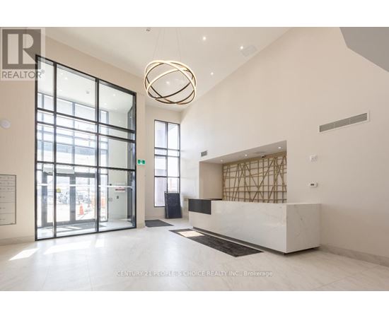 A reception area with a white marble counter and a large circular light fixture.