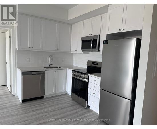 A kitchen with white cabinets and stainless steel appliances.
