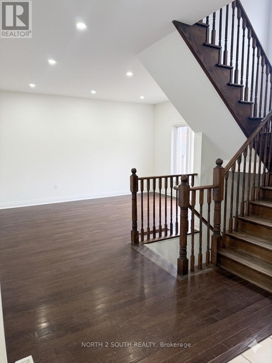 A wooden staircase with a white wall in the background.
