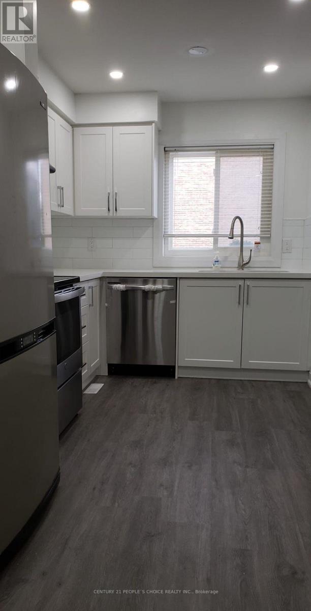 A modern kitchen with a dishwasher and a refrigerator.