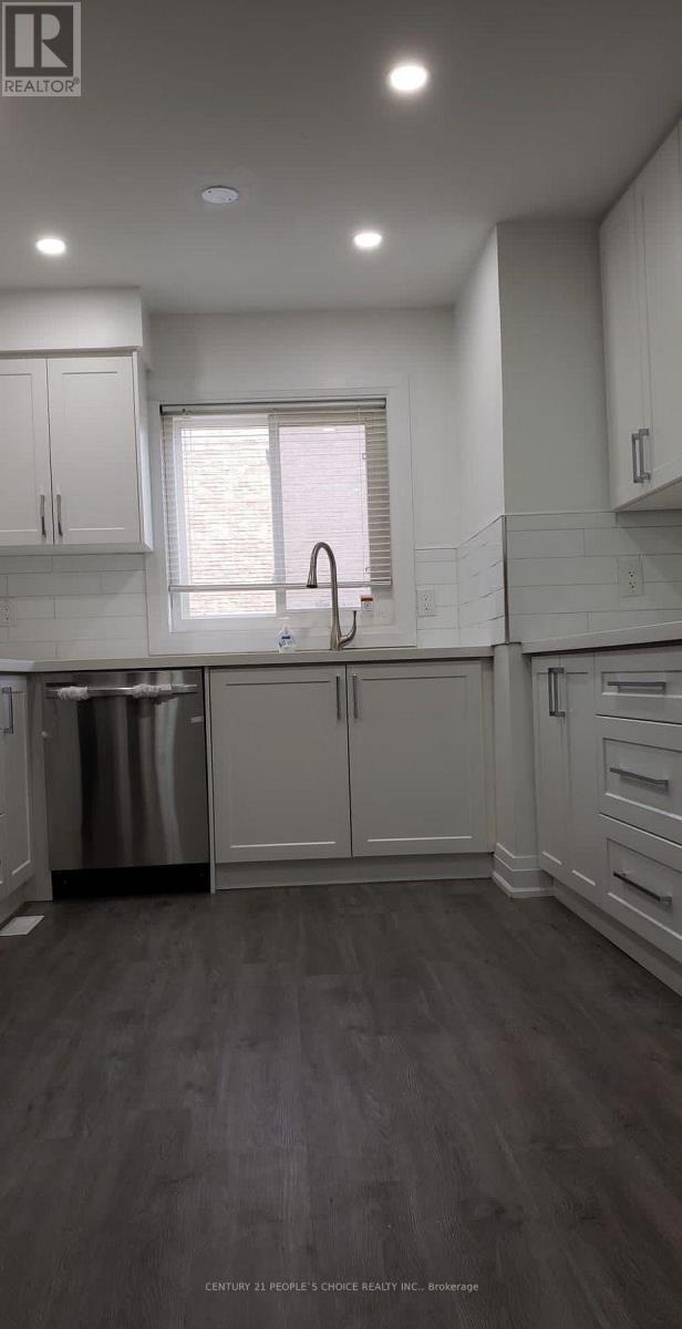 A kitchen with white cabinets and a stainless steel dishwasher.