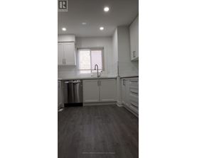 A kitchen with white cabinets and a stainless steel dishwasher.