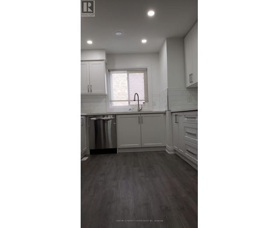 A kitchen with white cabinets and a stainless steel dishwasher.