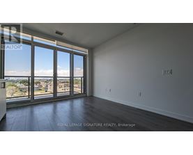 A room with a large window overlooking a cityscape.