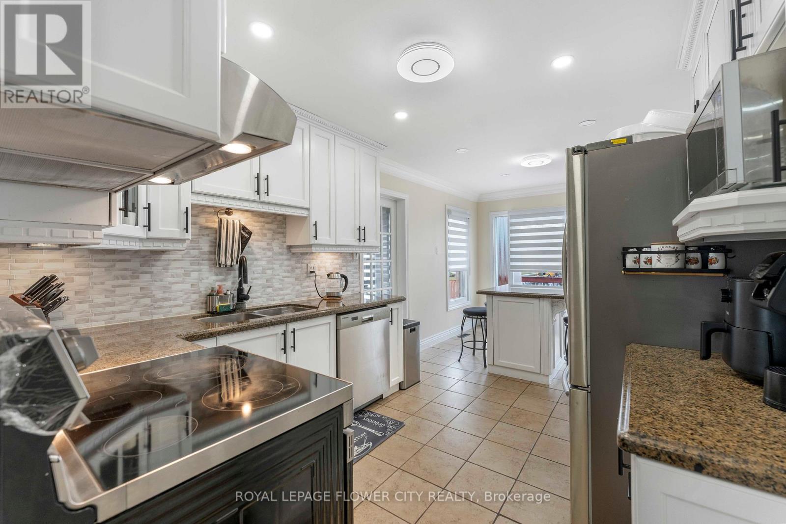 A kitchen with a stove top oven and a refrigerator.