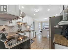 A kitchen with a stove top oven and a refrigerator.