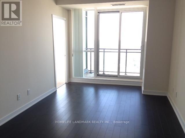 A room with a large window and sliding glass door.