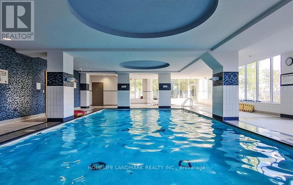 A swimming pool inside a building with a sign that says "REALTOR".