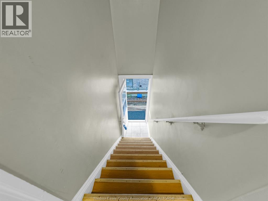 A staircase with wooden steps leading to a blue pool.