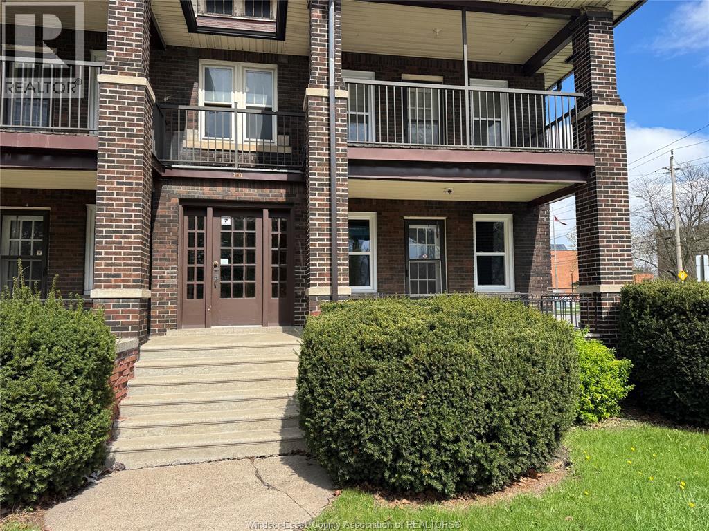 A building with a balcony and a brown door.