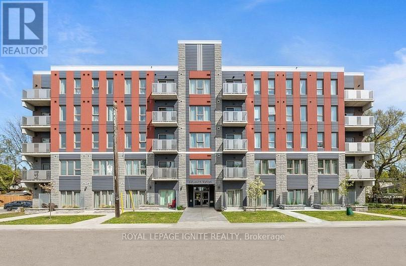 A modern apartment building with a clear blue sky in the background.