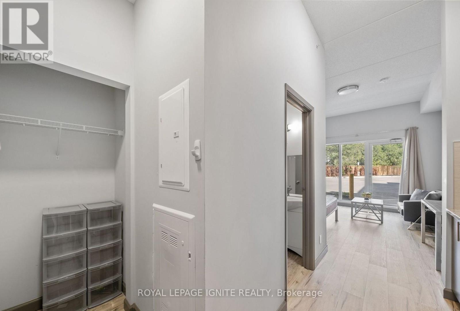 A white room with a door leading to a balcony.