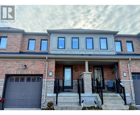 A house with a brick facade and a garage door is for sale.