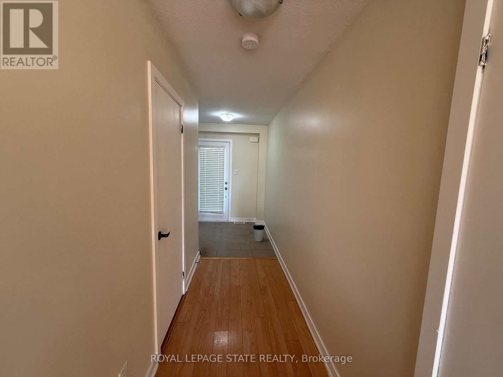 A hallway with a door on the left and another door on the right.