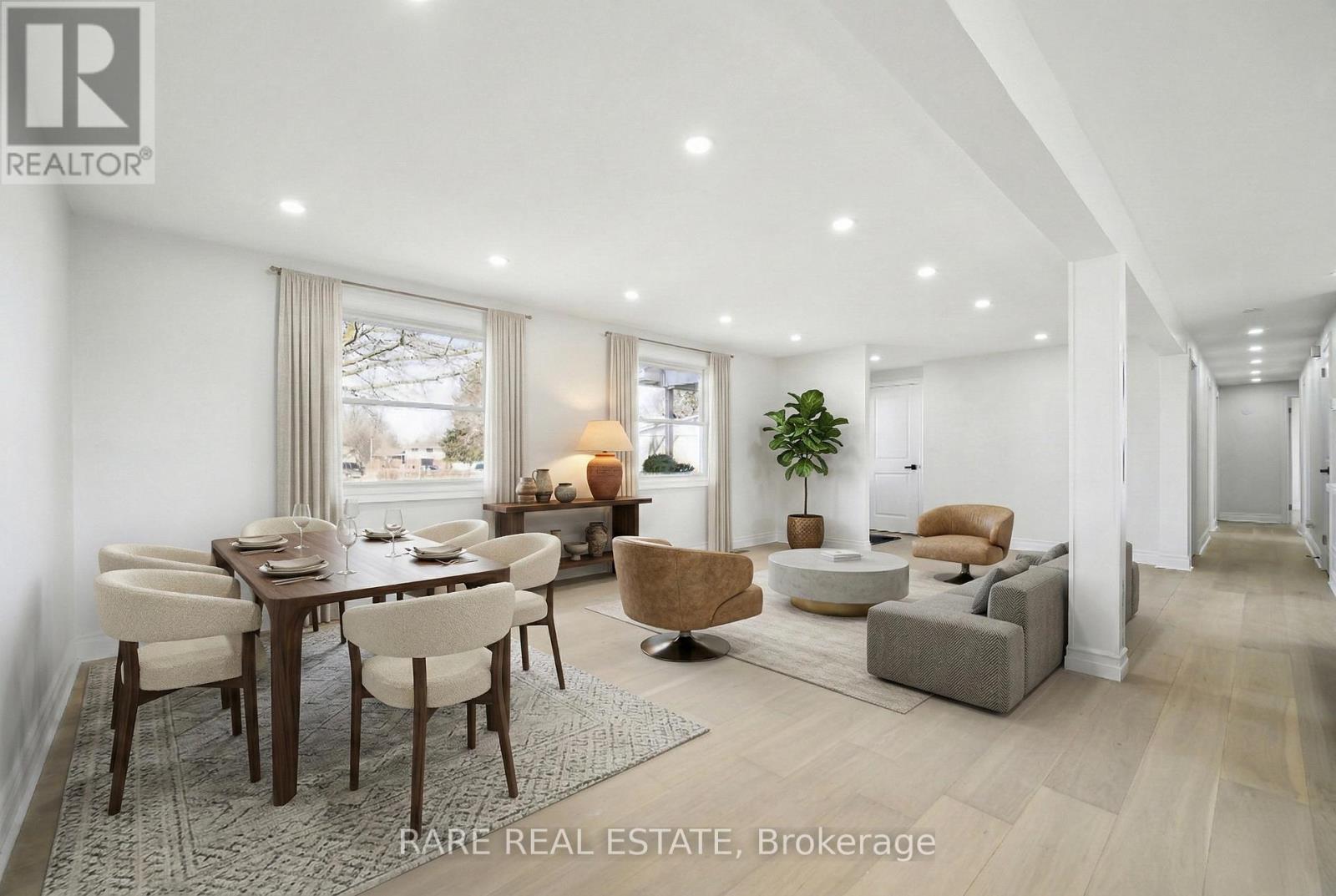 A well-lit, spacious living room with a dining table and chairs.