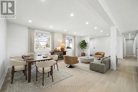 A well-lit, spacious living room with a dining table and chairs.