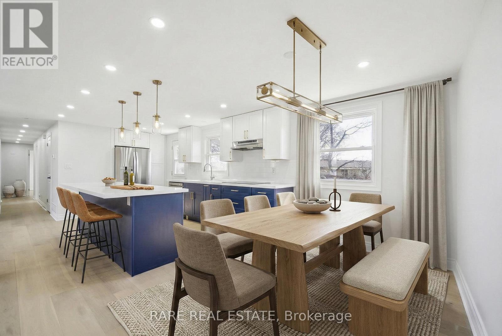 A modern kitchen with a dining table and chairs.