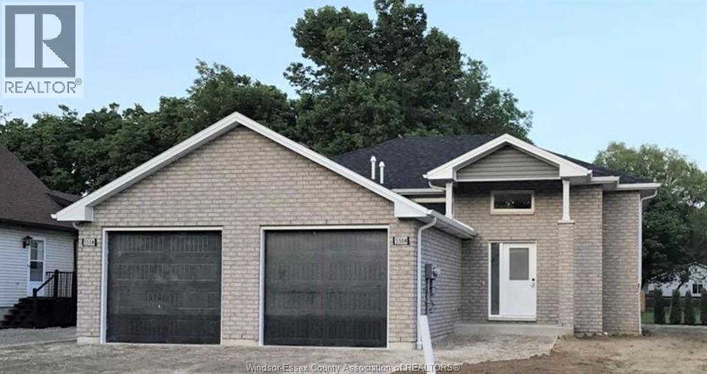 A two-story house with a garage is for sale.