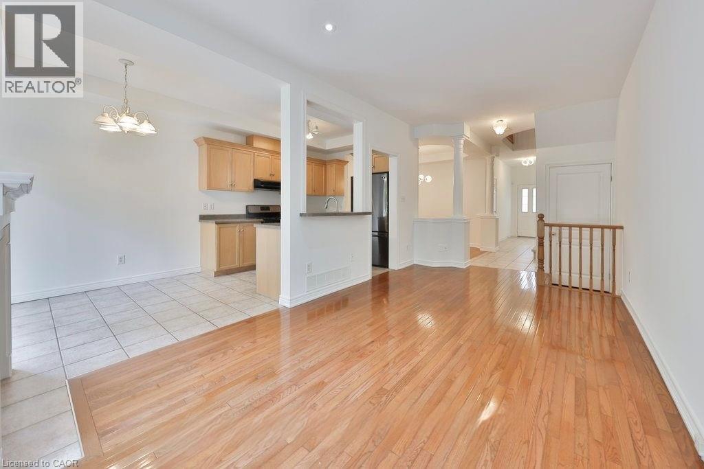 A spacious room with wooden floors and white walls.