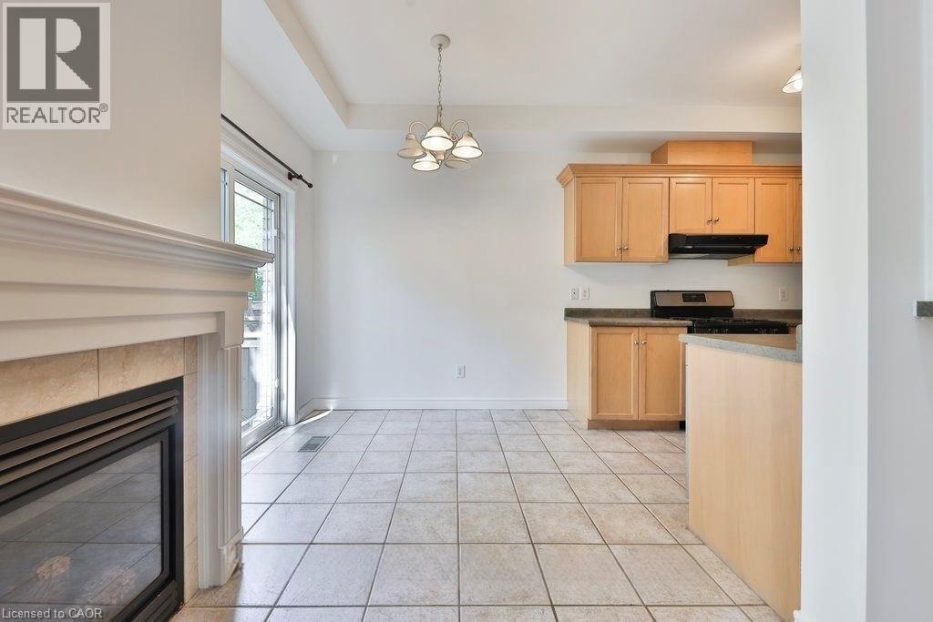 A well-lit kitchen with wooden cabinets and a tiled floor.