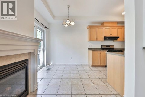 A well-lit kitchen with wooden cabinets and a tiled floor.