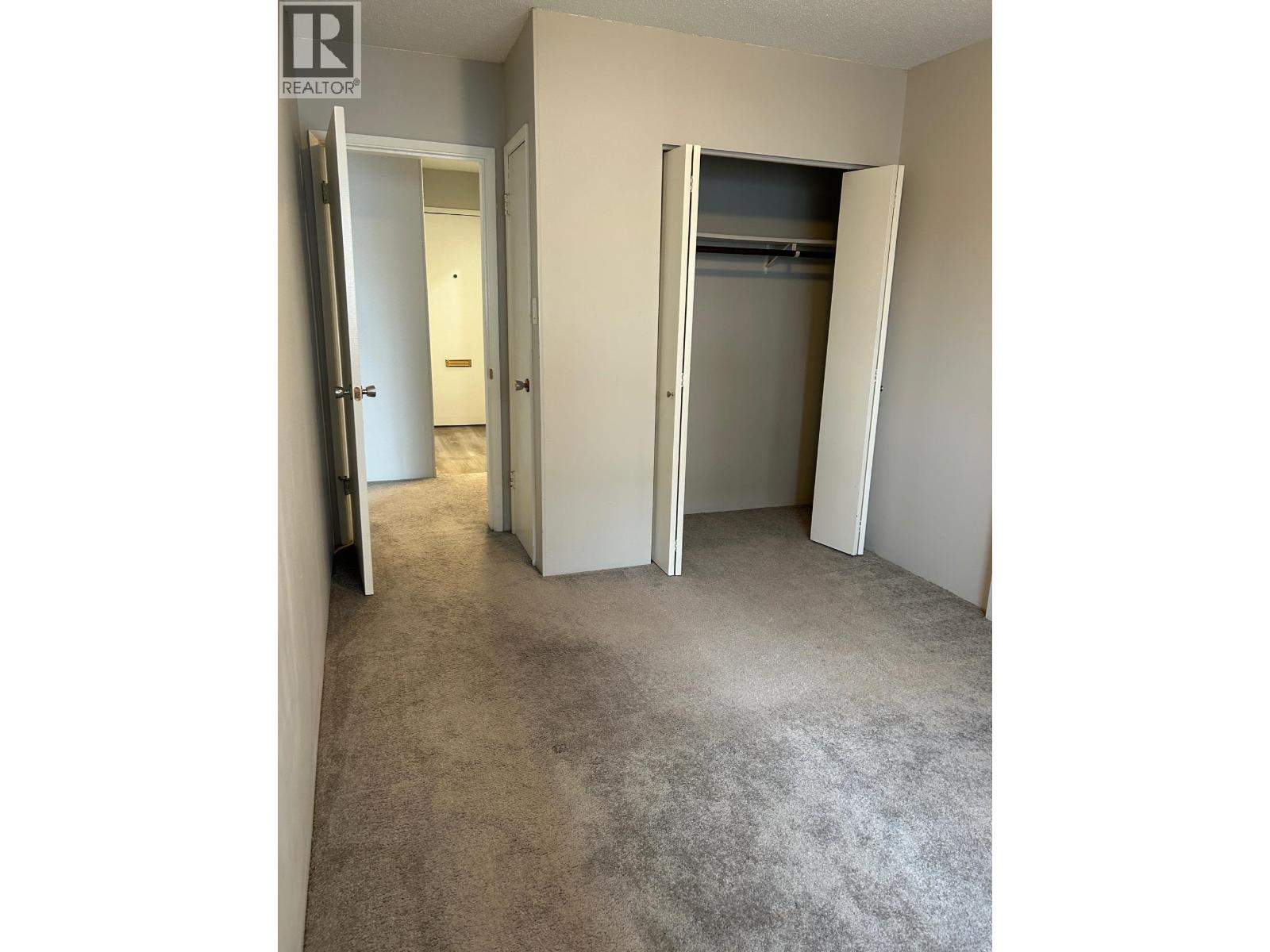 A realtor's office showing a bedroom with a closet.