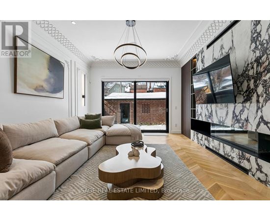 A living room with a beige couch and a coffee table in the center.