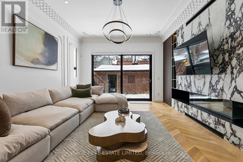 A living room with a beige couch and a coffee table in the center.