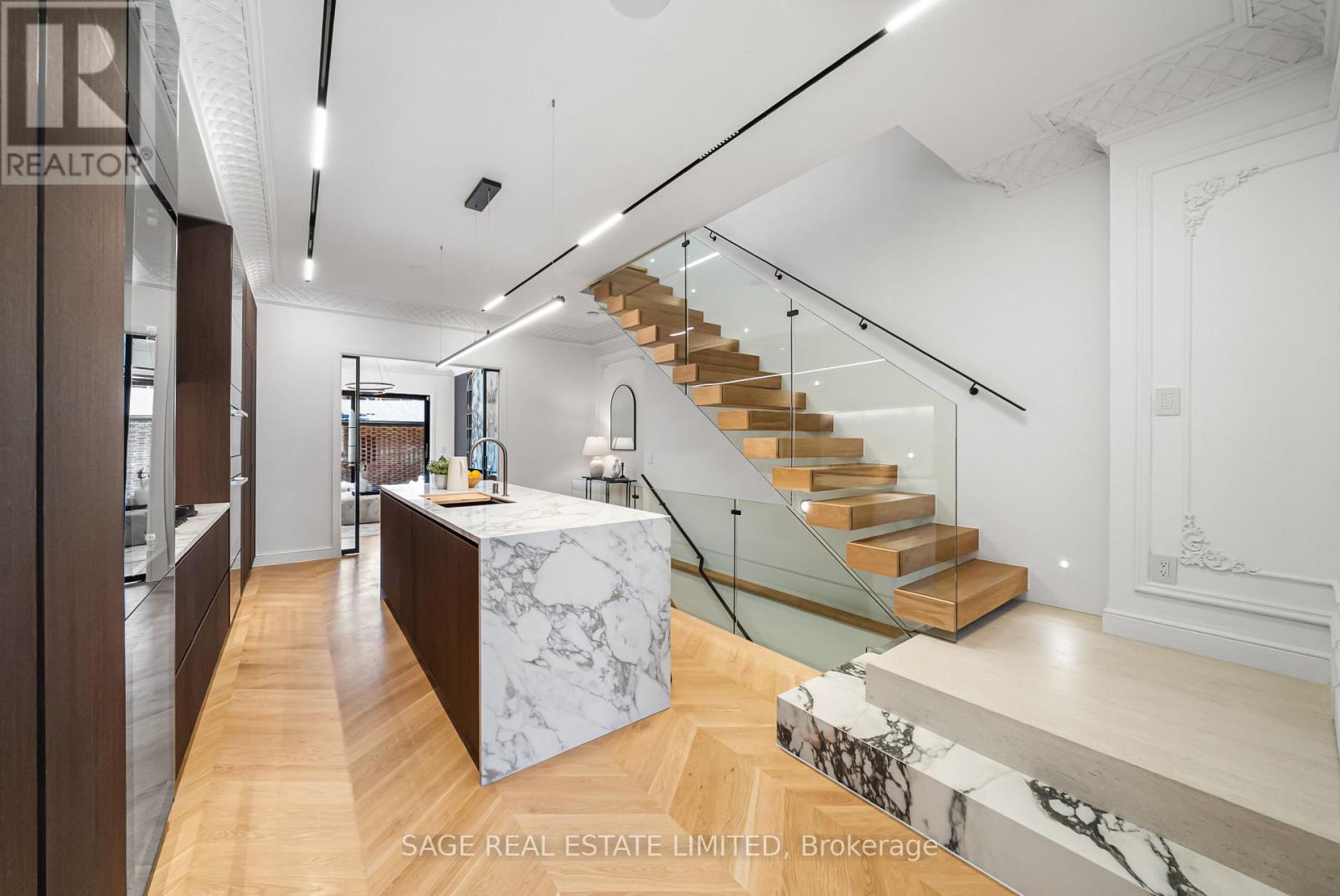 A modern interior space with a staircase and a reception desk.