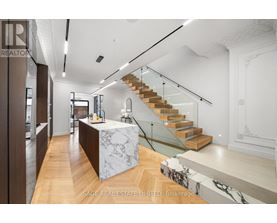A modern interior space with a staircase and a reception desk.