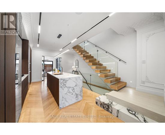 A modern interior space with a staircase and a reception desk.