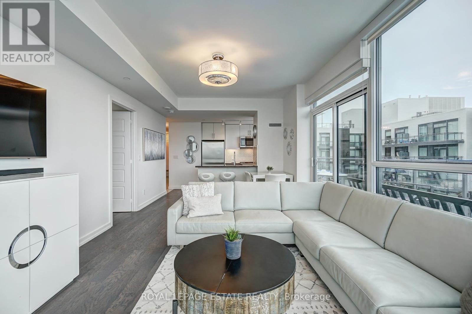 A living room with a white couch and a coffee table.